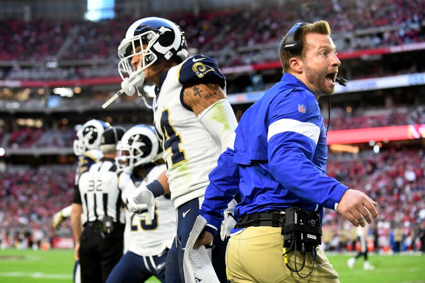 Rams safety Taylor Rapp, left, is congratulated by coach Sean McVay after he scored on an interception return.