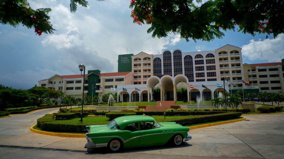 A vintage car passes in front of the Four Points by Sheraton hotel in Havana. President Trump announced a new policy that would bar individual Americans from traveling to Cuba under the so-called people-to-people exemption.