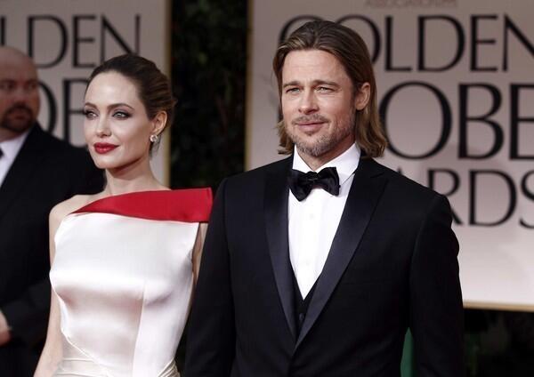 Breaking! Brad Pitt walked around and -- get this -- opened the limo door for Angelina Jolie! This was actually a point of conversation between the E! red carpet pre-show hosts. But did he smile at her? E! hosts did not say. Expect an in-depth "Frontline"-style E! special soon to find out the answer to this.