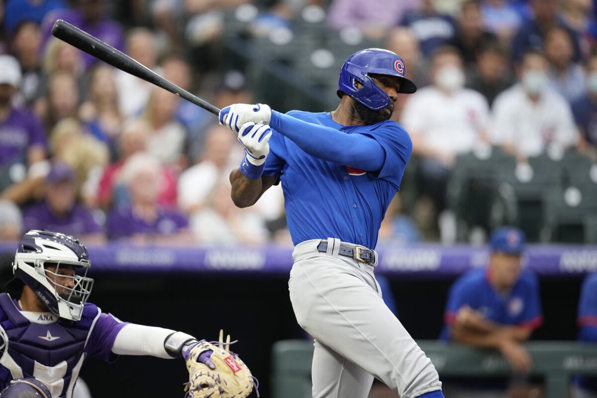 Chicago Cubs' Jason Heyward, right, grounds out to drive in a run against Colorado Rockies starting pitcher Kyle Freeland in the second inning of a baseball game Tuesday, Aug. 3, 2021, in Denver. (AP Photo/David Zalubowski)