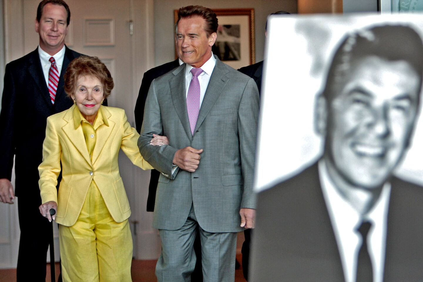 Nancy Reagan is joined by California Gov. Arnold Schwarzenegger and Assemblyman Martin Garrick (R-Carlsbad), left, at a signing ceremony for two bills honoring her late husband at the Reagan library in Simi Valley.