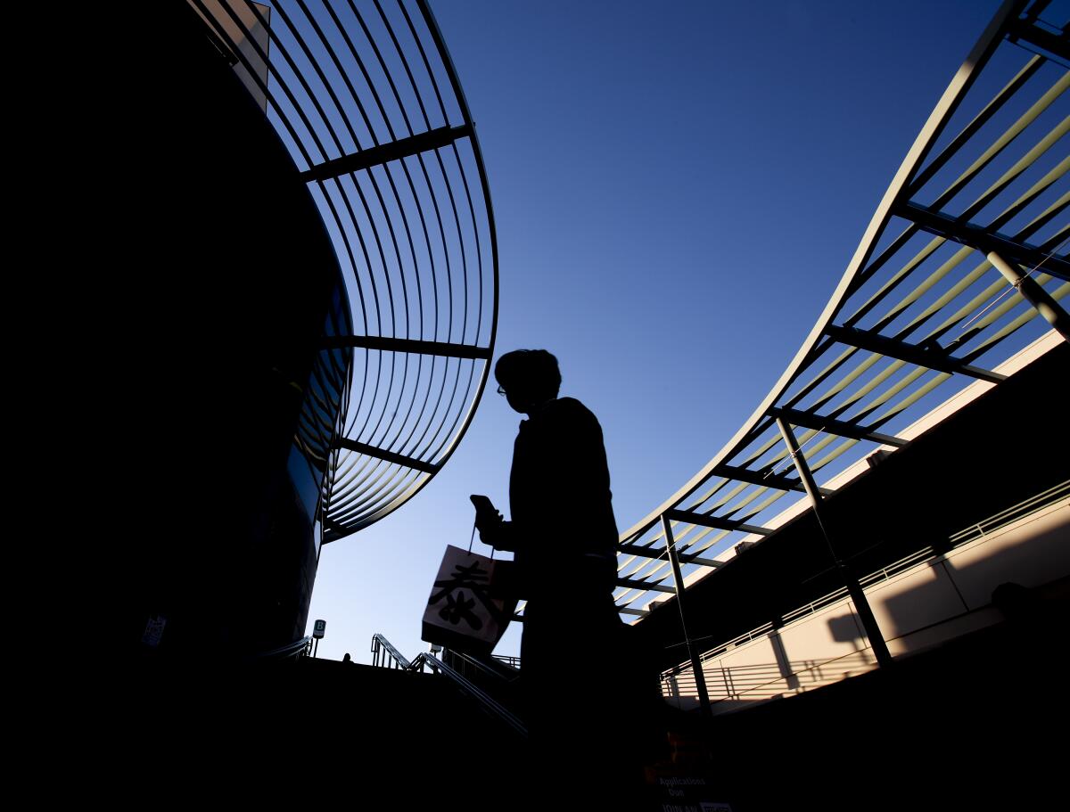 A student is silhouetted at sunset at Pasadena City College.