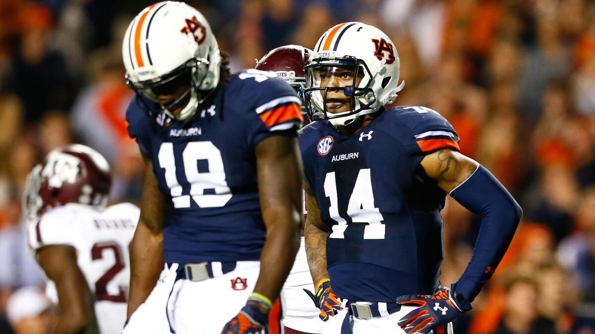 Auburn's Sammie Coates, left, and Nick Marshall walk off the field after Marshall fumbled on the two-yard line during a 41-38 loss to Texas A&M on Saturday.