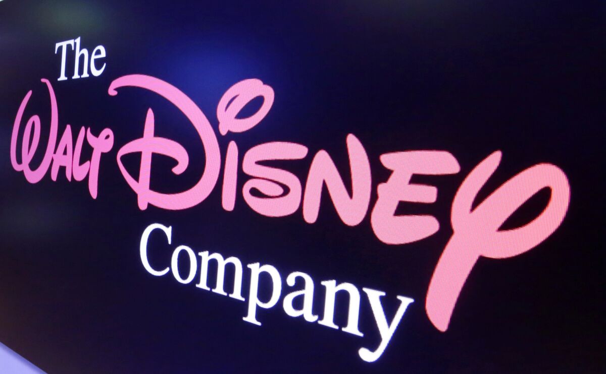 FILE - The Walt Disney Co. logo appears on a screen above the floor of the New York Stock Exchange on Aug. 7, 2017. The third straight Pixar feature film will go straight to Disney+, the Walt Disney Co. announced Friday, Jan. 7, 2022. "Turning Red" will premiere exclusively on Disney+ on March 11, the studio said. Kareem Daniel, chairman of distribution for Disney, cited the pandemic and the slower recovery for family films at the box office. (AP Photo/Richard Drew, File)