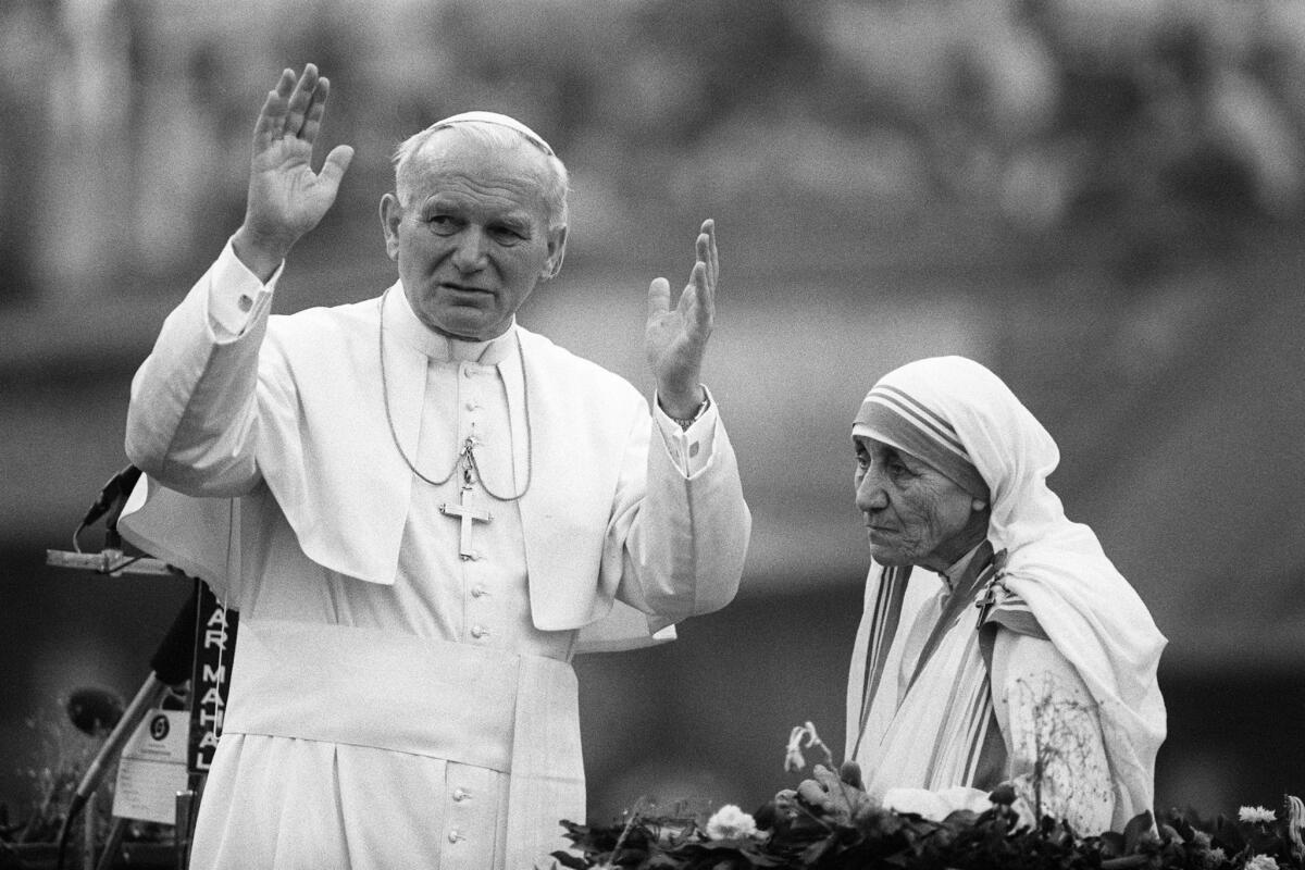 Mother Teresa and Pope John Paul II wave to well-wishers in Kolkata in February 1986.