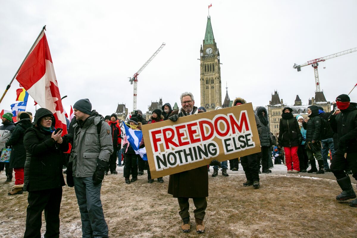 Protesters on Parliament Hill to support trucks lined up in protest of COVID-19 vaccine mandates in Ottawa, on Saturday