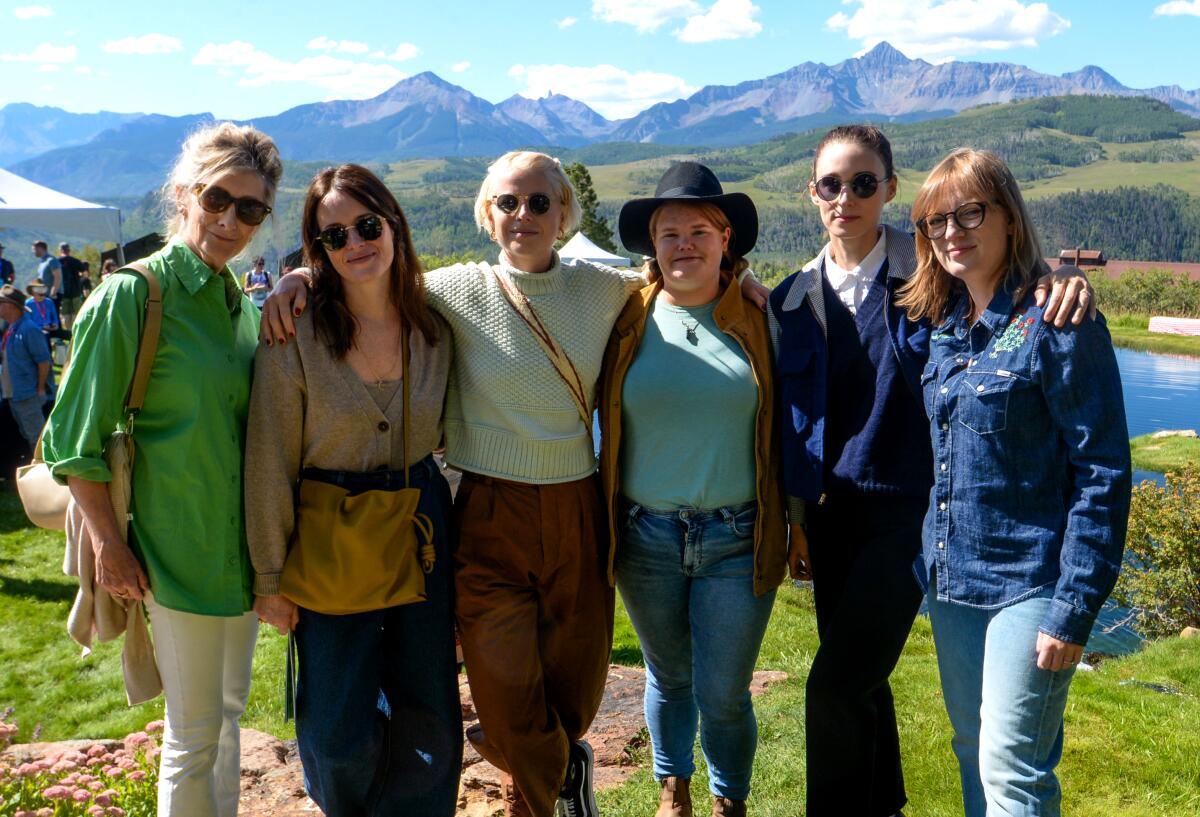 Five women dressed casually stand outside with mountains in the background at the Telluride Film Festival