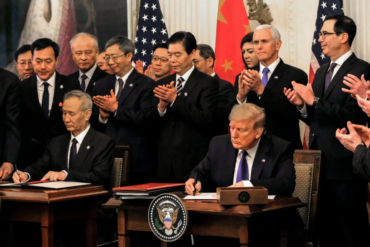 President Trump and Chinese Vice Premier Liu He sign the "phase 1" trade deal between the U.S. and China on Jan. 15. But costs for medical supplies are still high.