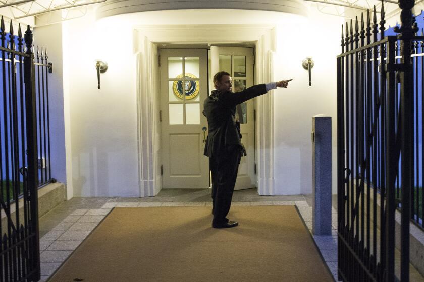 A Secret Service agent gives directions after a fence jumper made his way into the White House.