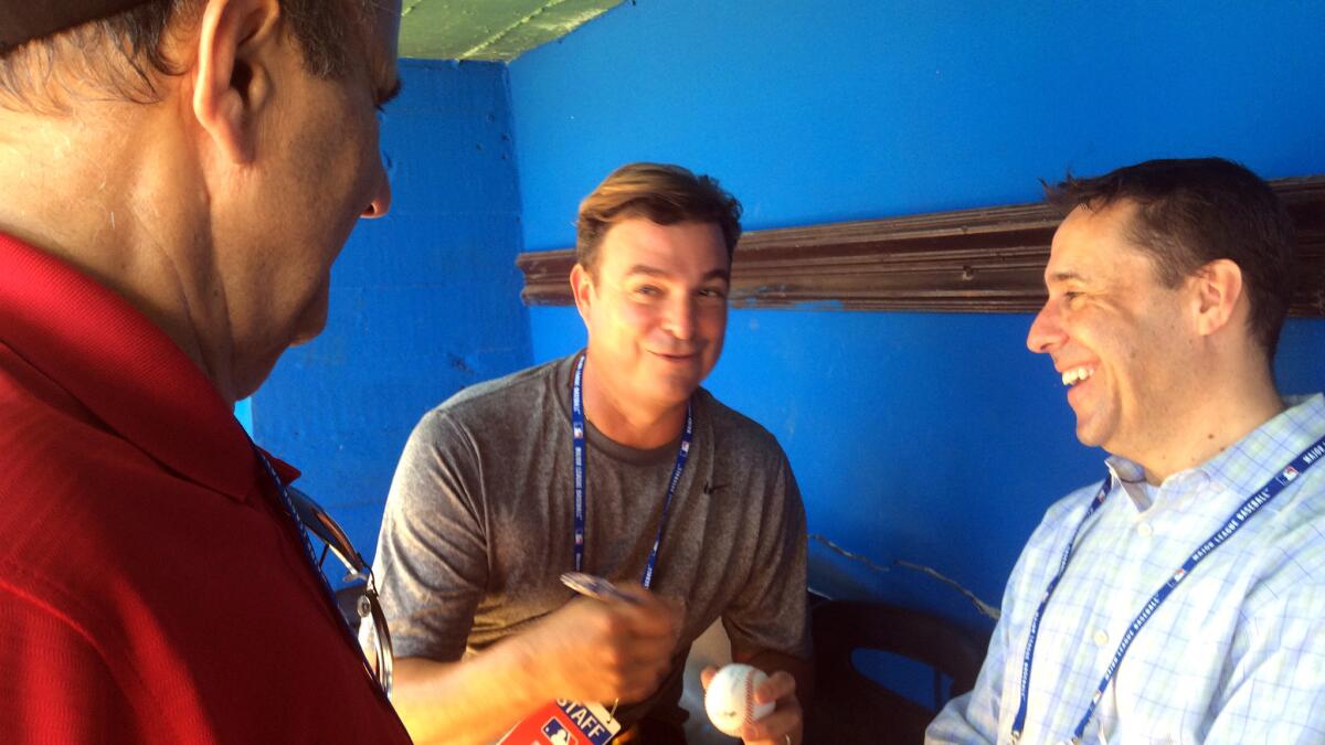 Antonio Castro, center, talks to MLB executive Joe Torre, left, and Dan Halem, MLB's top lawyer and the point man on talks with Cuba.