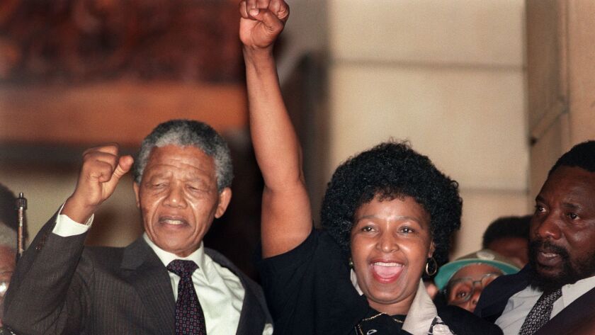 In this file photo taken on Feb. 11, 1990, anti-apartheid leader and African National Congress member Nelson Mandela and his wife, Winnie, raise their fists in Paarl, South Africa, to salute a cheering crowd upon Mandela's release from Victor Verster prison.