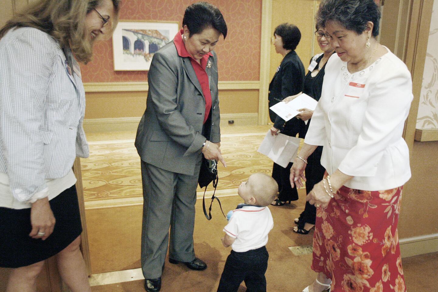 Former Glendale zoning administrator Edith Fuentes, center, says hello to her grand nephew, Eli Autten, 1, during her campaign kickoff for city council at Hilton in Glendale on Thursday, September 20, 2012.