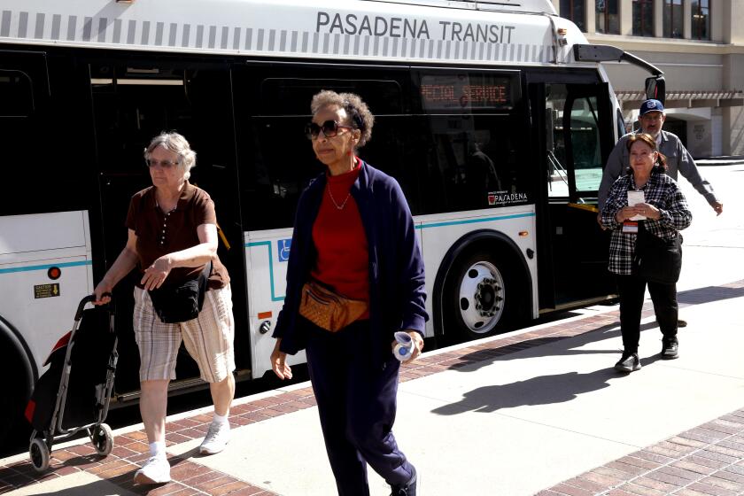PASADENA, CA - MAY 7, 2024 - Seniors exit a Pasadena transit bus to participate in the 8th Annual Older Adult Transportation Expo at the Pasadena Convention Center in Pasadena on May 7, 2024. (Genaro Molina/Los Angeles Times)