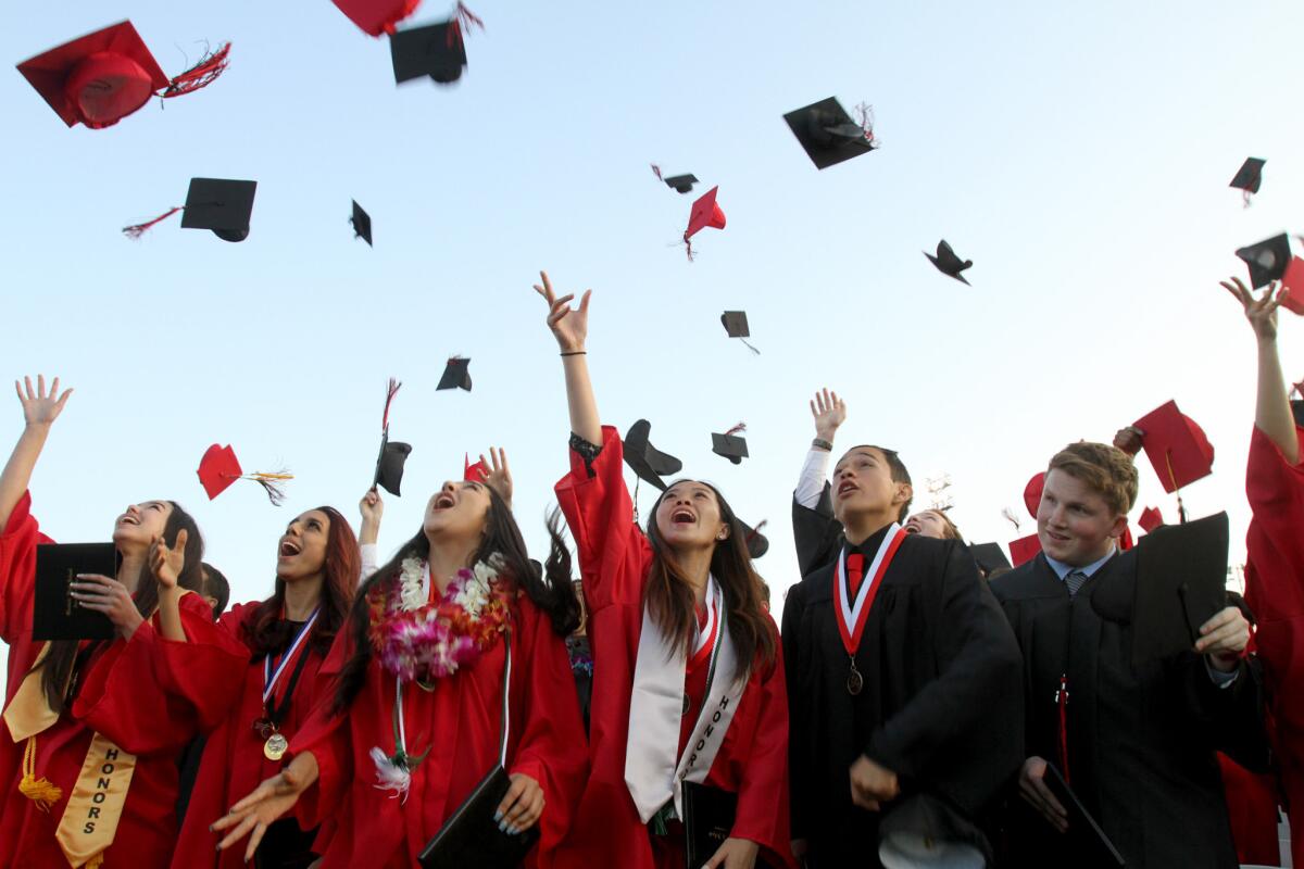 Glendale High School graduates toss their caps into the air at the end of the 2015 commencement at the school's Moyse Field in this June 2015 photo.