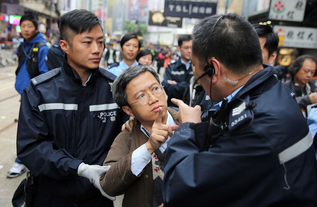 A Hong Kong resident argues with police when asked to leave the pro-democracy protest site in the Causeway Bay district on Dec. 15.