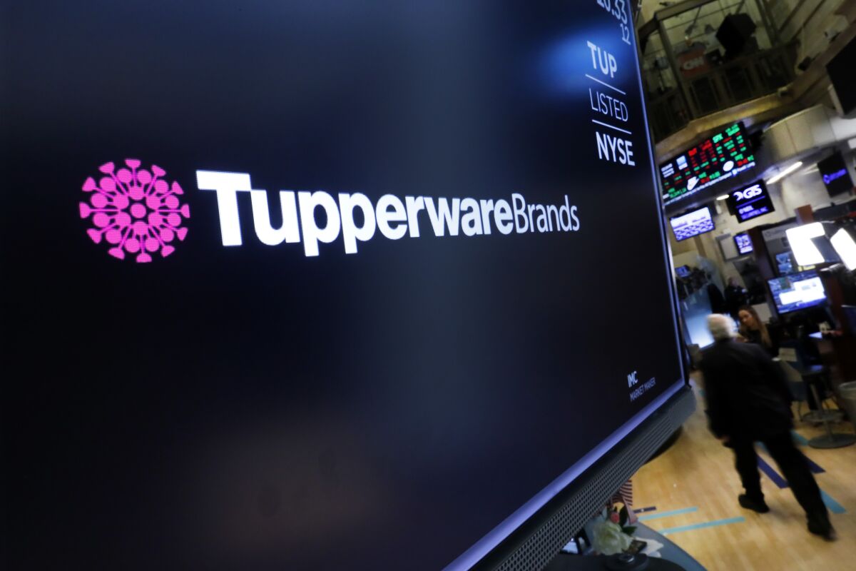 FILE - In this Oct. 30, 2019 file photo, the logo for Tupperware Brands appears above a trading post on the floor of the New York Stock Exchange. Sales dropped 16% in the first quarter, with Miguel Fernandez, President and CEO of Tupperware Brands, acknowledging that the company’s turnaround still needs a lot more work. The company withdrew its financial projections for the rest of the year and named a new chief financial officer. The company's stock shed a third of its value. (AP Photo/Richard Drew)