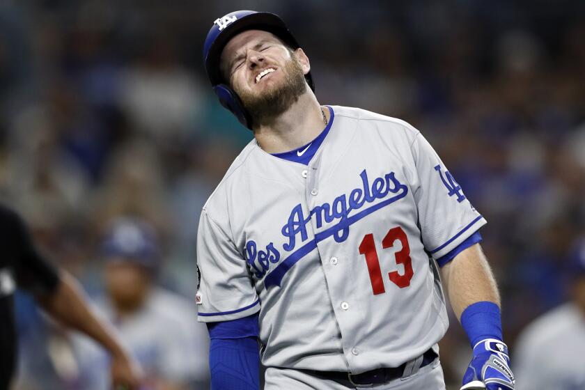 Los Angeles Dodgers' Max Muncy (13) reacts after being hit on the arm while batting during the fifth inning of the team's baseball game against the San Diego Padres on Wednesday, Aug. 28, 2019, in San Diego. (AP Photo/Gregory Bull)