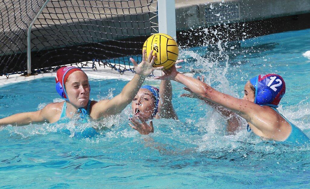 Corona del Mar High goalie Heidi Ritner, left, and Maddie Musselman converge to disrupt a shot attempt in the quarterfinals of the CIF Southern Section Division 1 playoffs at CdM.