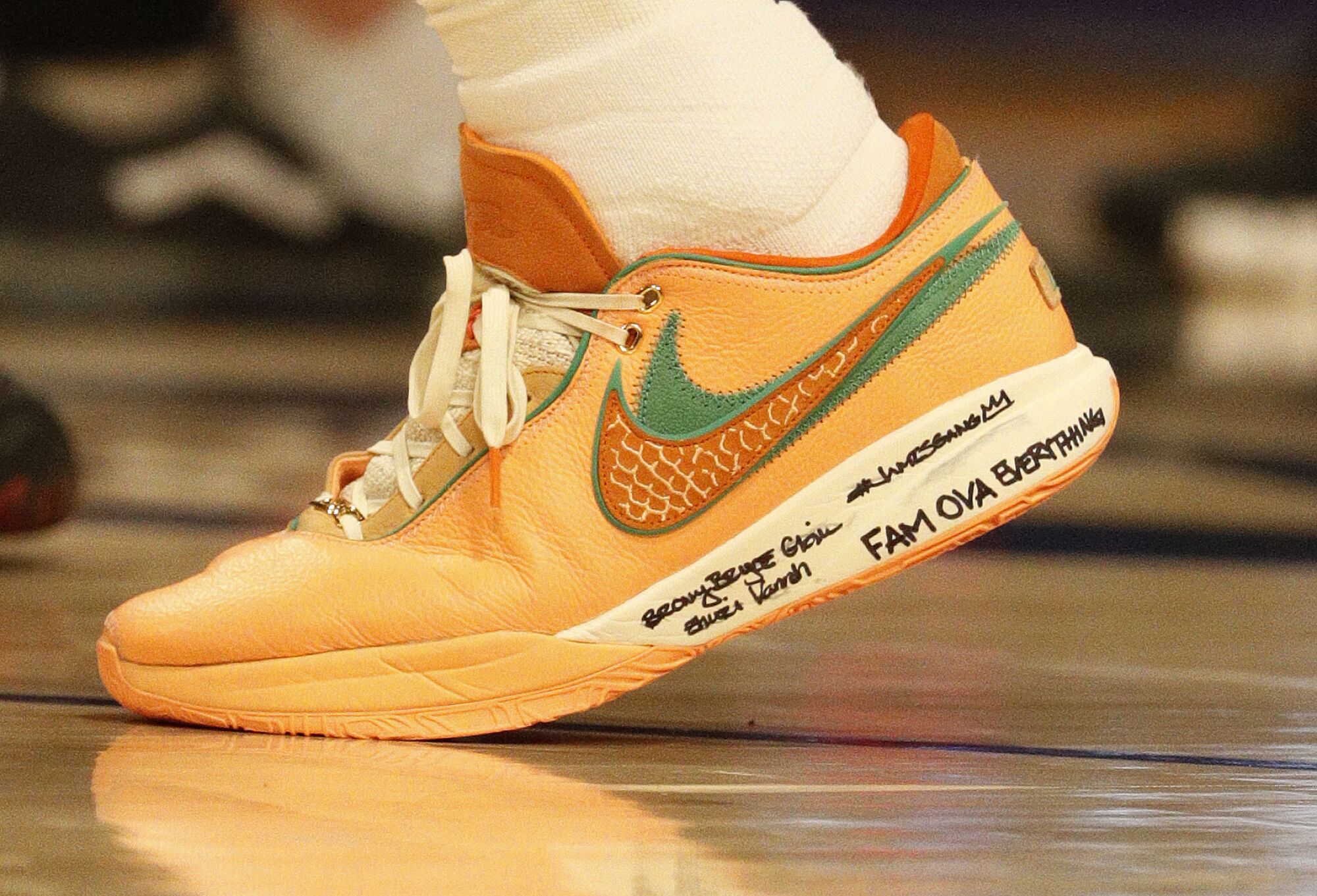 The shoe of Lakers forward LeBron James displays his family's names and "FAM OVA EVERYTHING" written on the side.