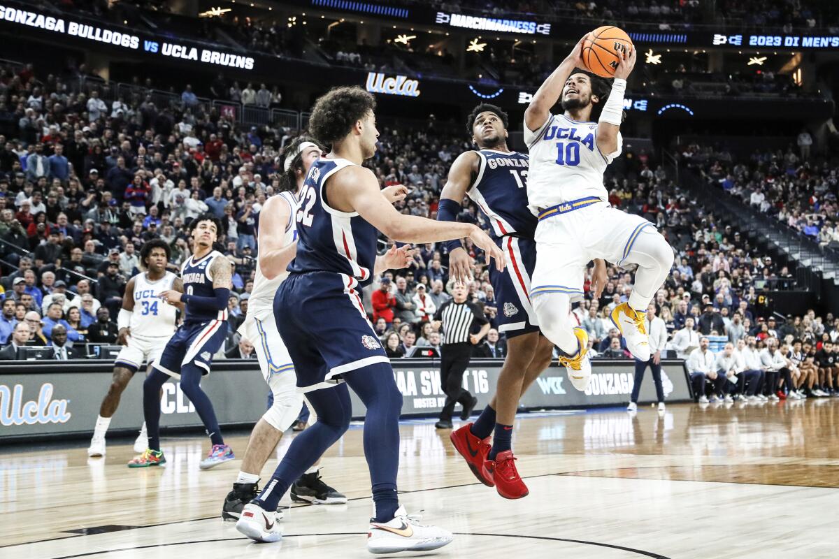 UCLA guard Tyger Campbell goes airborne to get a shot off against Gonzaga late in a Sweet 16 game March 23, 2023.