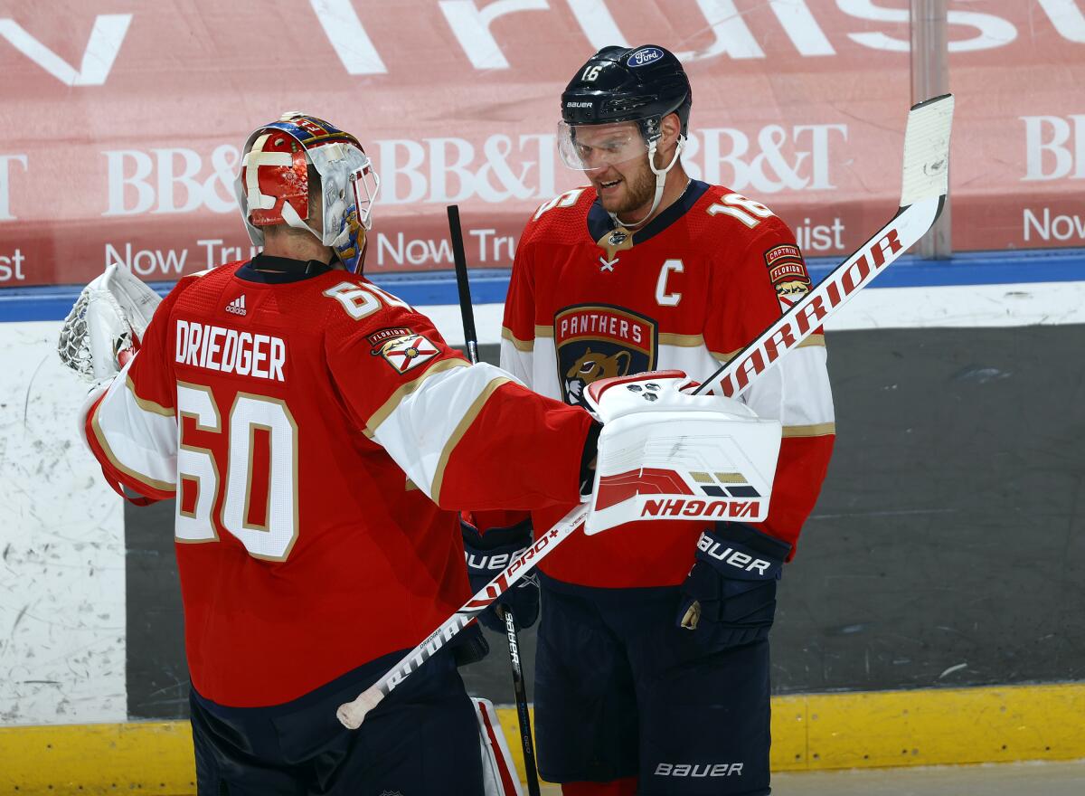 Florida Panthers center Aleksander Barkov gives a fan a hockey