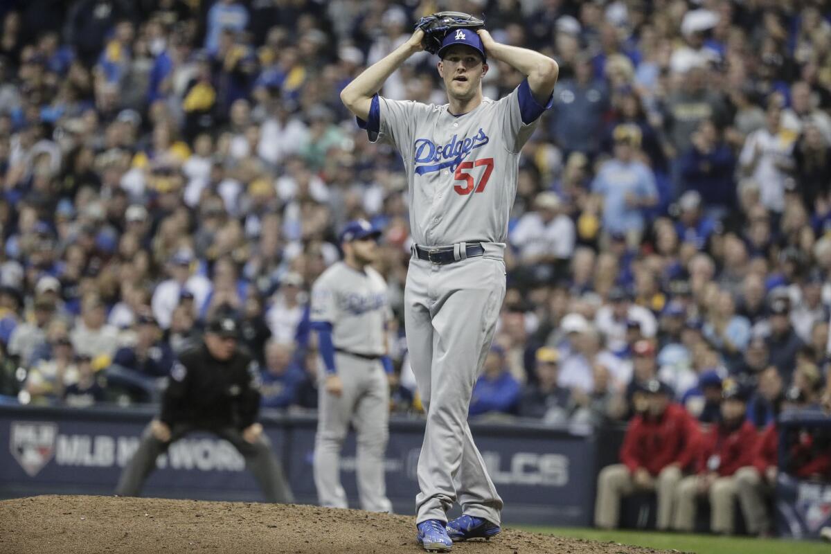 Dodgers pitcher Alex Wood shows the look of disbelief after hitting Brewers hitter Erik Kratz in the fifth inning.