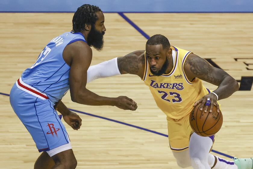 Los Angeles Lakers forward LeBron James (23) drives with the ball against Houston Rockets guard James Harden (13) during the first quarter of an NBA basketball game Tuesday, Jan. 21, 2021, in Houston. (Troy Taormina/Pool Photo via AP)
