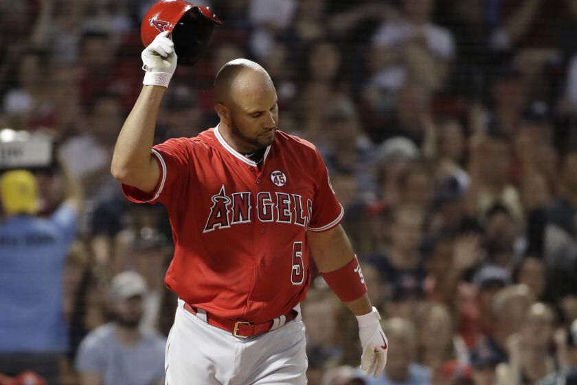 Los Angeles Angels' Albert Pujols tosses his helmet after striking out against Boston Red Sox starting pitcher Chris Sale during the seventh inning of a baseball game at Fenway Park, Thursday, Aug. 8, 2019, in Boston. (AP Photo/Elise Amendola)