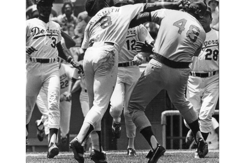 June 19, 1977: Dodgers Reggie Smith lands a punch on Chicago Cubsâ pitcher Rick Reuschel after Reuschel hit Smith in the angle with a pitch in third inning in game at Dodger Stadium. This photo was published in the June 20, 1977 Los Angeles Times.