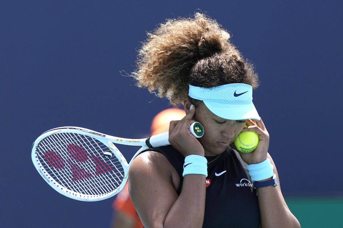 Naomi Osaka covers her ears during her match against Maria Sakkari in the quarterfinals of the Miami Open on March 31.
