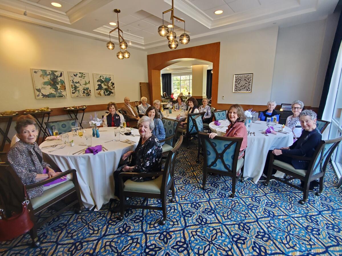 Members and guests of a book club gather for lunch at Vi at La Jolla Village in 2022. 