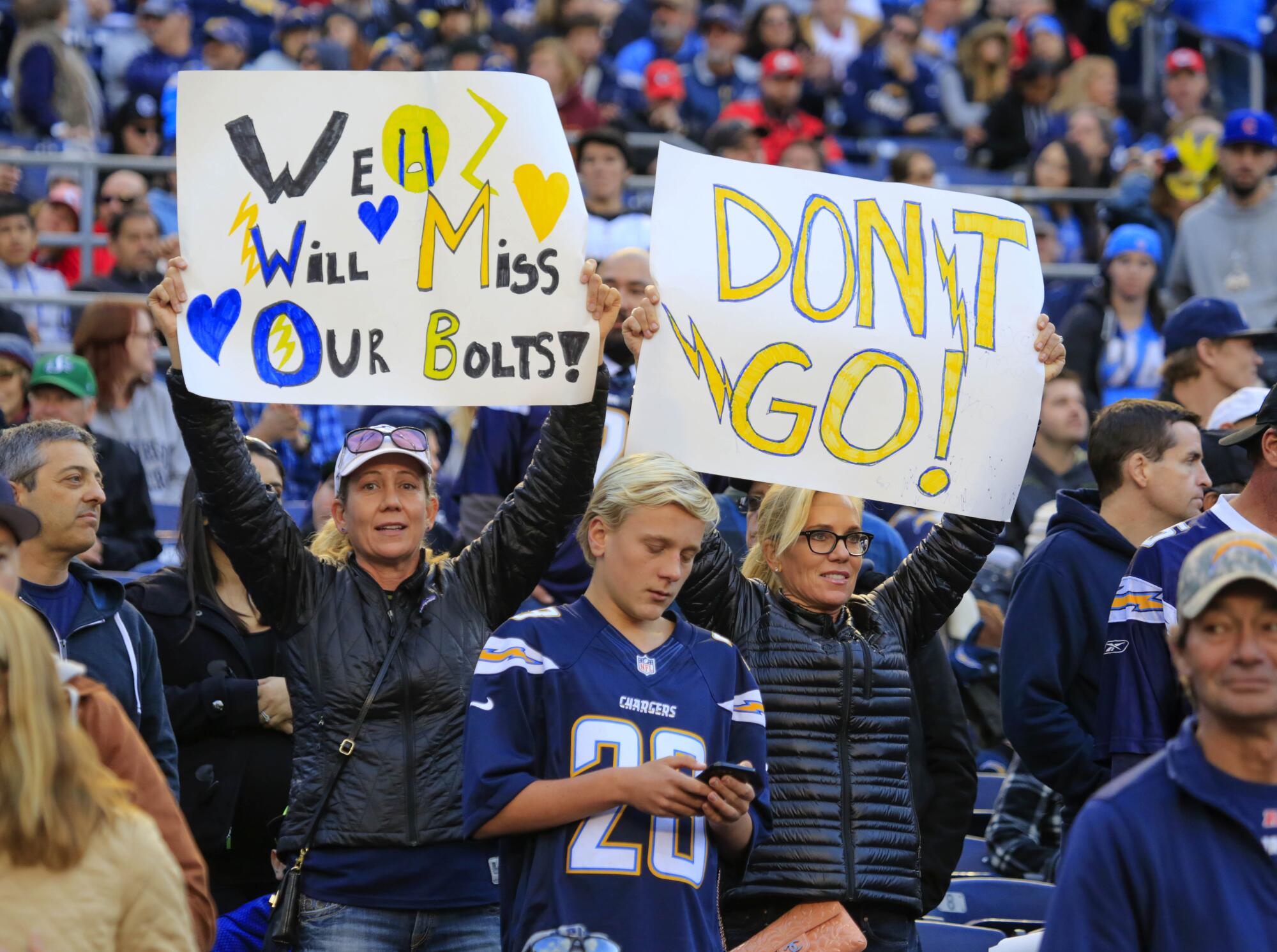 Chargers fans held signs expressing sadness if the team leaves San Diego, and asking them not to go. 