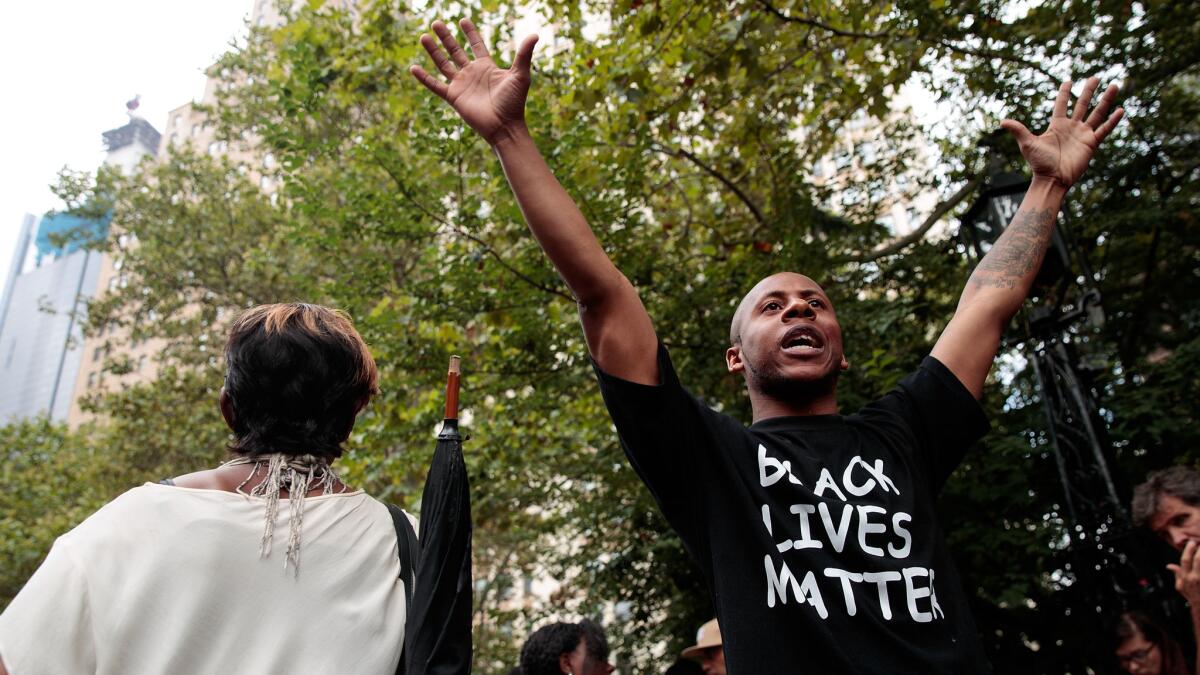 Protestors rally against police brutality near New York City Hall on Monday.