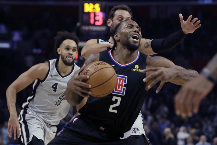 Clippers forward Kawhi Leonard drives to the basket during the second half of a game against he Spurs at Staples Center.