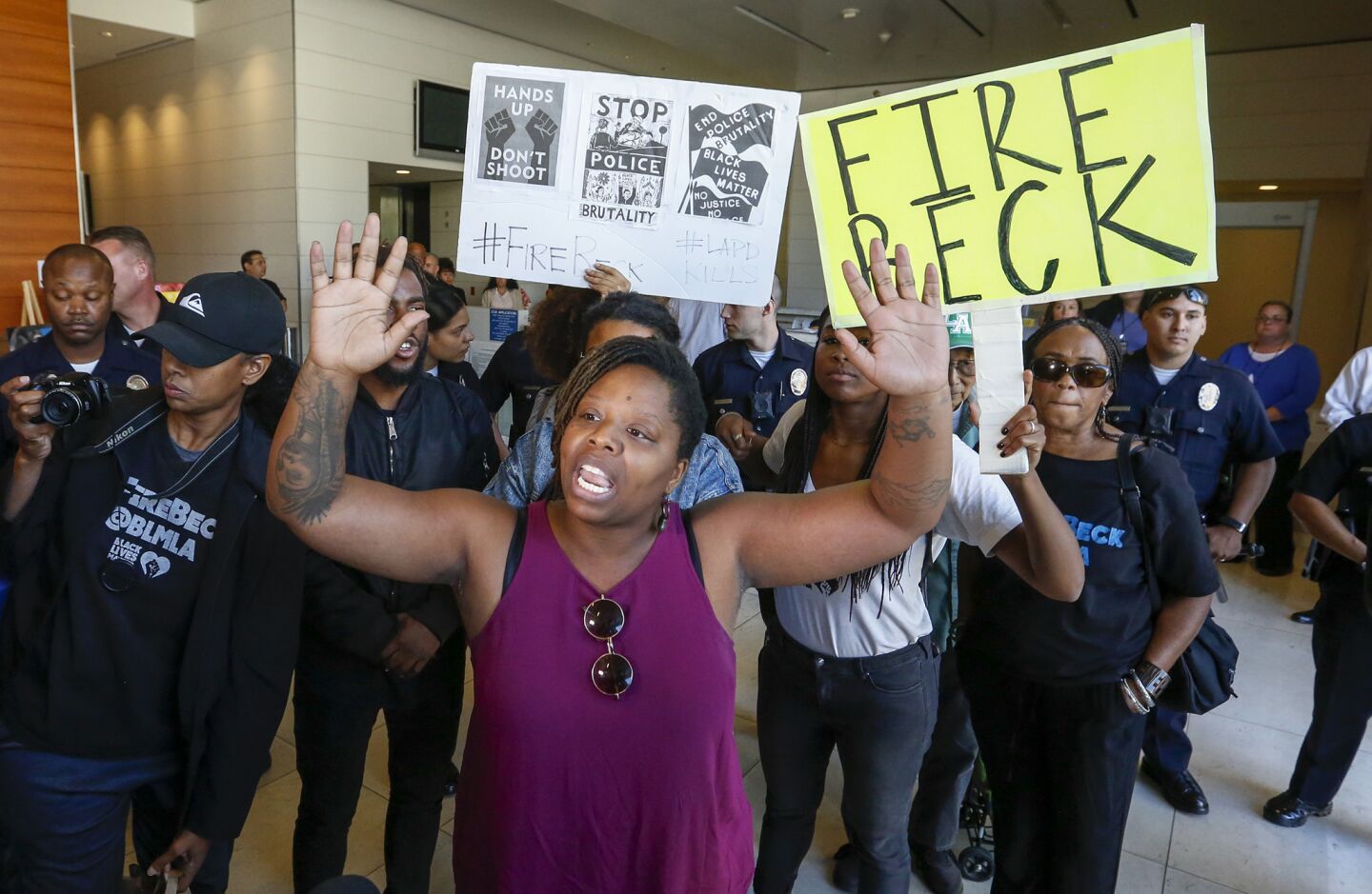 Protesters shout out their messege inside the lobby of LAPD headquarters after Police Chief Charlie Beck gave details to the media about the officer-involved shooting death of Carnell Snell Jr.