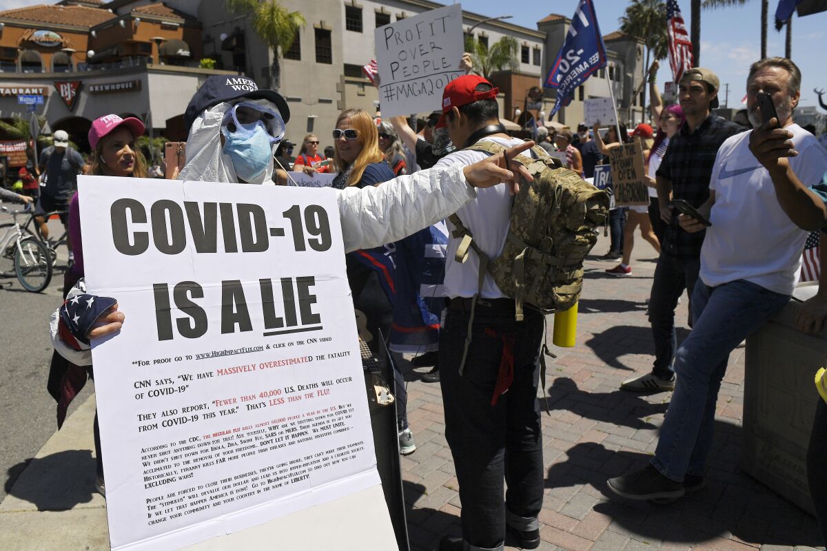 Protesters demonstrate in Huntington Beach on April 17 against stay-home orders that were put in place due to the COVID-19 pandemic. 