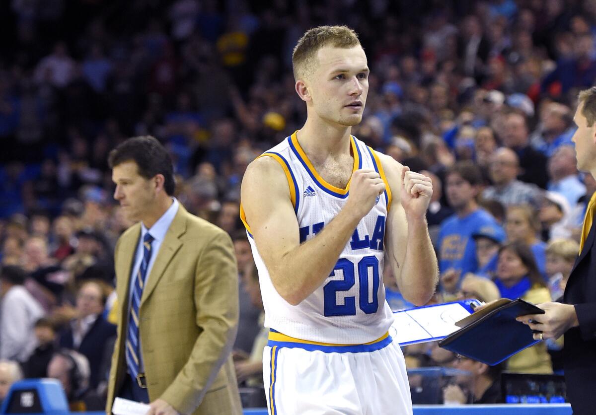 UCLA guard Bryce Alford, right, celebrates as his father, Coach Steve Alford, stands in the background in the closing seconds of the second half of a game against Arizona on Jan. 7.