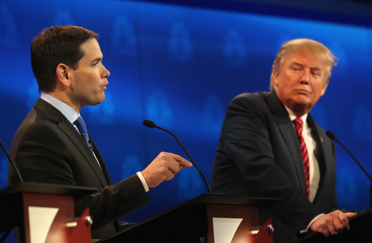 Republican presidential hopeful Sen. Marco Rubio of Florida speaks while Donald Trump looks on during the Republican debate Wednesday night. Rubio's strong performance seems likely to boost his standing in the GOP field.