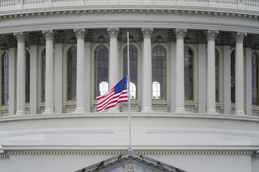 An American flag flies at half-staff in remembrance of U.S. Capitol Police Officer Brian Sicknick above the Capitol Building in Washington, Friday, Jan. 8, 2021. Sicknick died from injuries sustained as President Donald Trump's supporters stormed the Capitol. (AP Photo/Patrick Semansky)