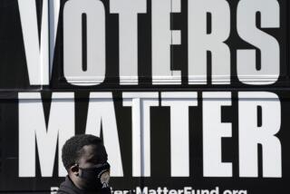 FILE - A man wearing a mask gathers with a group in support of Black Voters Matter at the Graham Civic Center polling site in Graham, N.C., Nov. 3, 2020. Some top Democrats are worried that a dip in Black voter turnout, along with other challenges, could doom President Joe Biden and his party in 2024. (AP Photo/Gerry Broome, File)