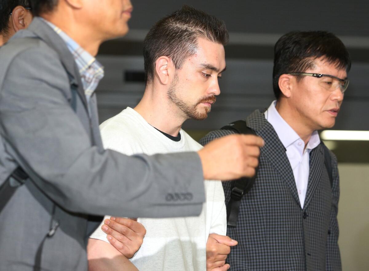Arthur Patterson, center, is escorted by South Korean police upon arriving at Incheon International Airport on Sept. 23, 2015.