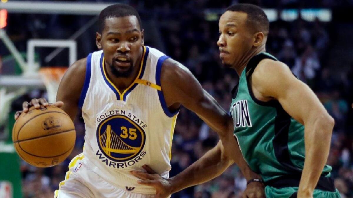 Warriors forward Kevin Durant drives against Celtics guard Avery Bradley during the third quarter of a game on Nov. 18.
