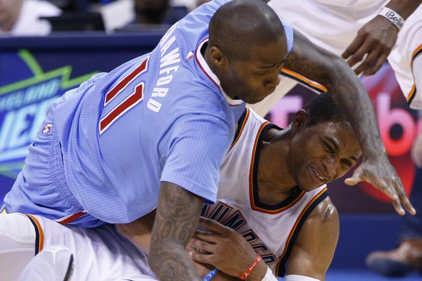 Clippers guard Jamal Crawford, left, and Oklahoma City Thunder guard Russell Westbrook battle for a loose ball during the Clippers' 131-108 loss on Feb. 8, 2015.