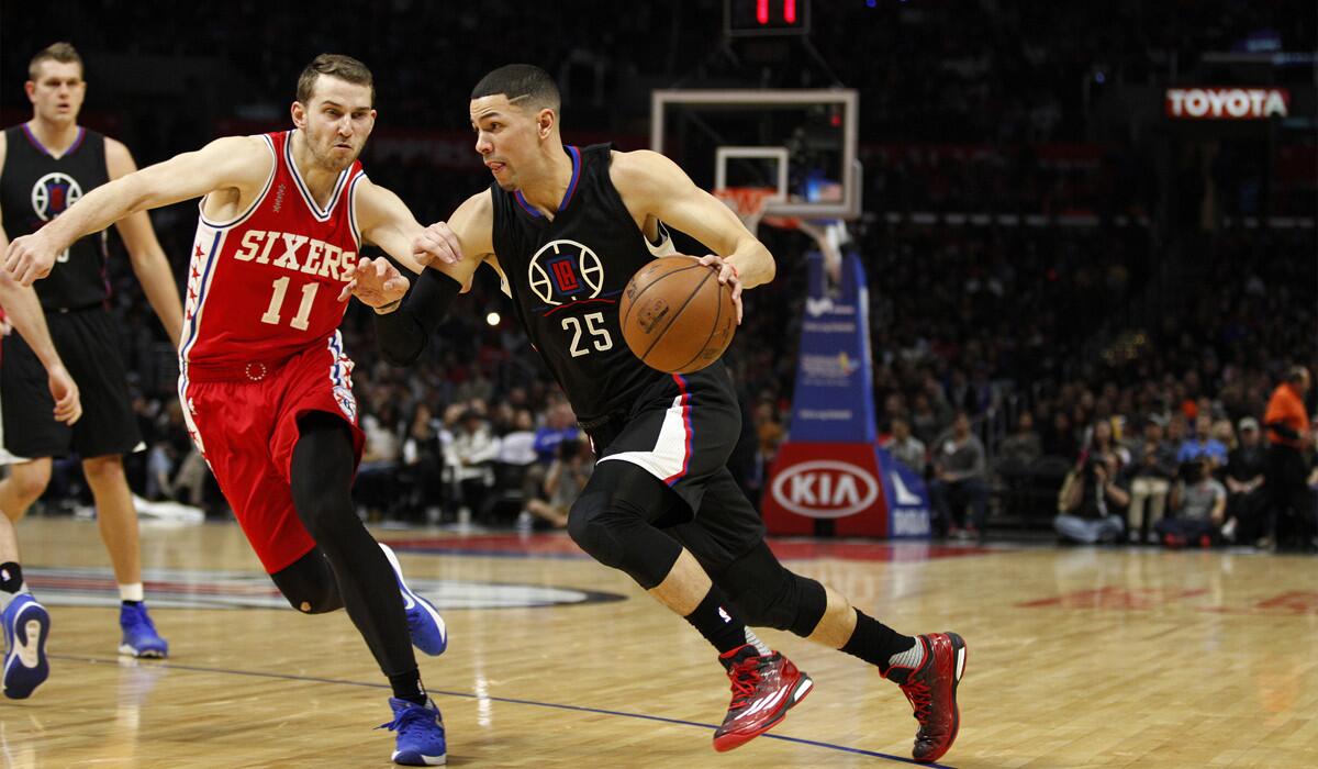 Guard Austin Rivers, driving against Philadelphia's Nik Stauskas, agrees to a $35.7-million, three-year deal to return to the Clippers.