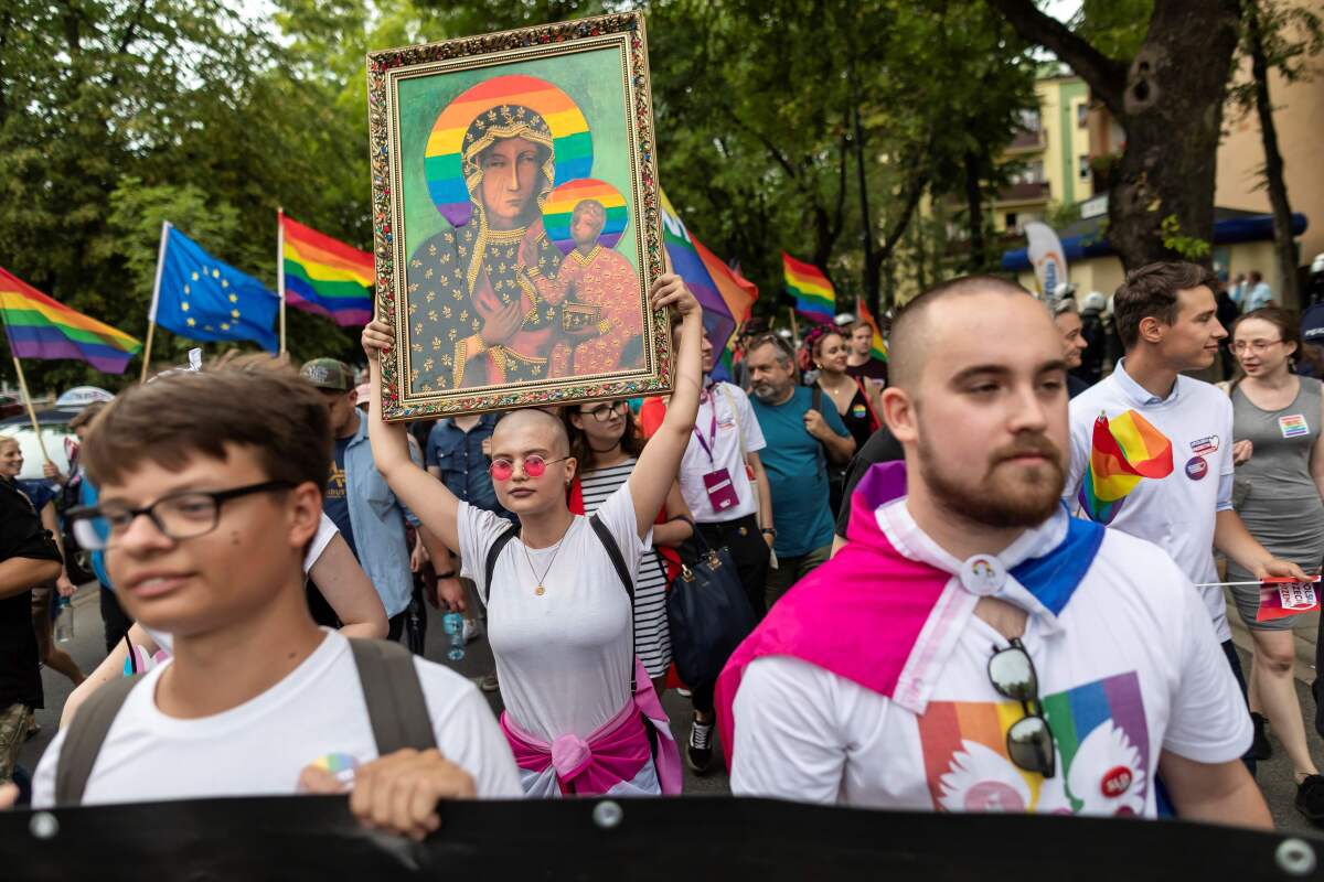 A demonstrator holds a picture depicting the Virgin Mary with a rainbow halo during a pride gathering in August in central Poland.