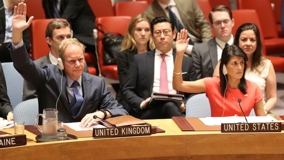 British Ambassador Matthew Rycroft and U.S. Ambassador Nikki Haley vote during a U.N. Security Council meeting on North Korea sanctions on Saturday in New York.