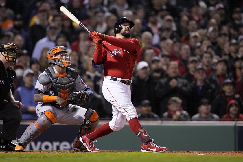 Boston Red Sox's Kyle Schwarber hits a grand slam home run against the Houston Astros during the second inning in Game 3 of baseball's American League Championship Series Monday, Oct. 18, 2021, in Boston. (AP Photo/David J. Phillip)