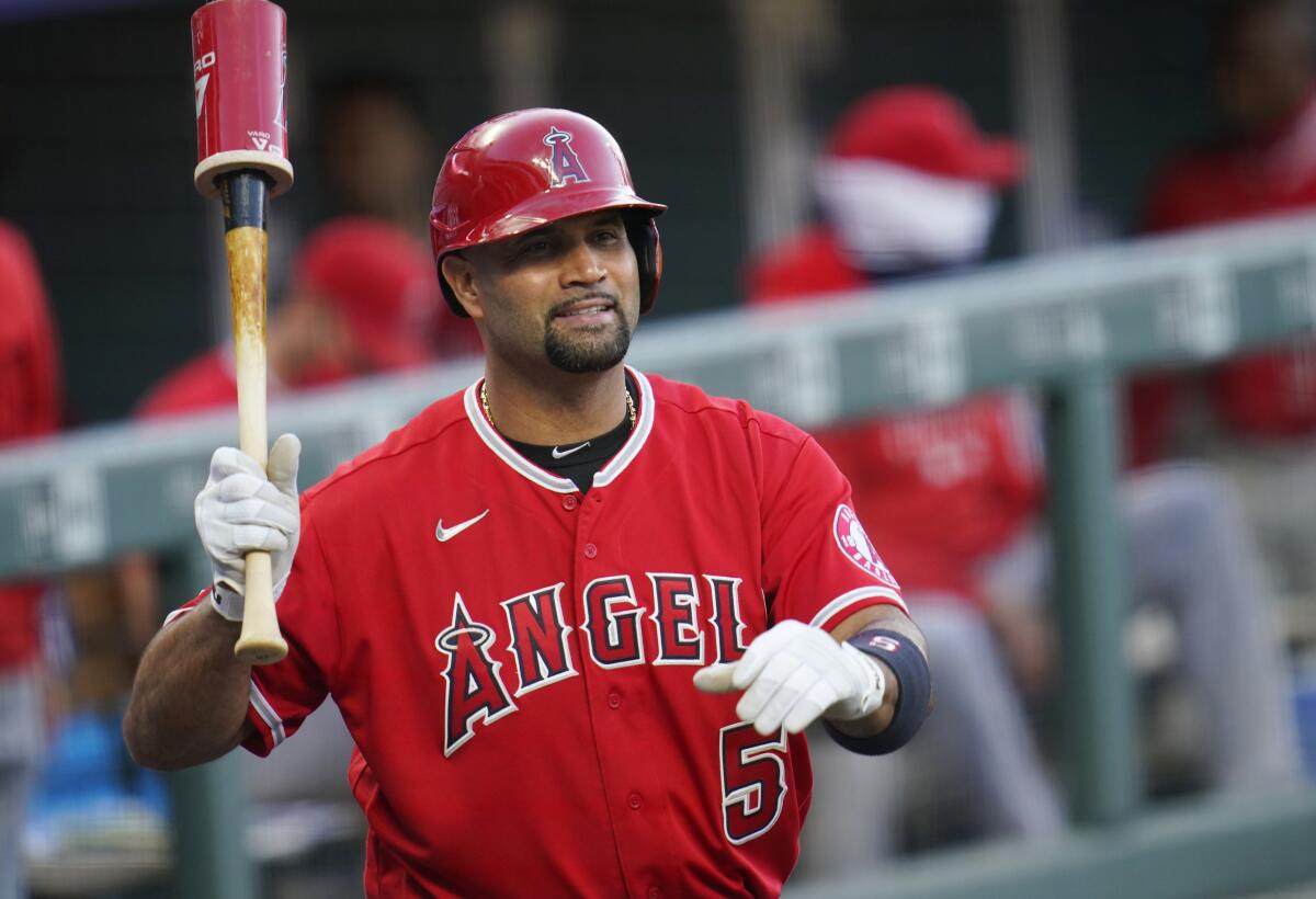 Angels designated hitter Albert Pujols waves to players in the Colorado Rockies' dugout during a game in September 2020.
