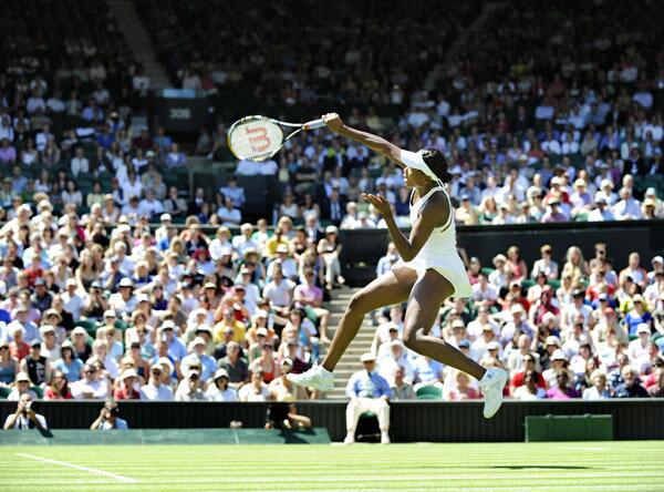 Venus Williams returns a ball to Switzerland