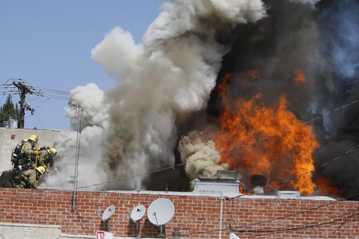 Firefighters battle a blaze at a carpet store in Burbank.